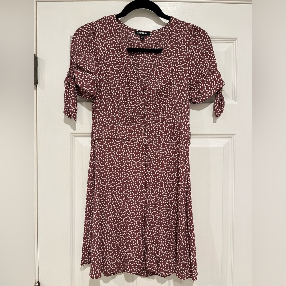 Cap sleeves with ties, buttons all down the front, V cut, tie detail in back.